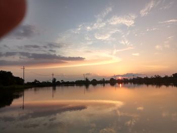 Scenic view of lake against sky during sunset