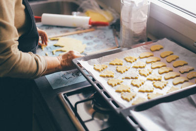 Midsection of woman preparing cookies