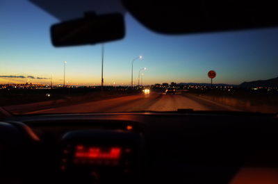 Cars on street seen through car windshield