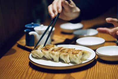 Close-up of hand holding food on table