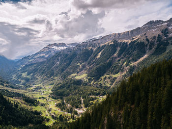 Scenic view of valley and mountains against sky