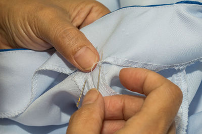 Midsection of tailor sewing textile