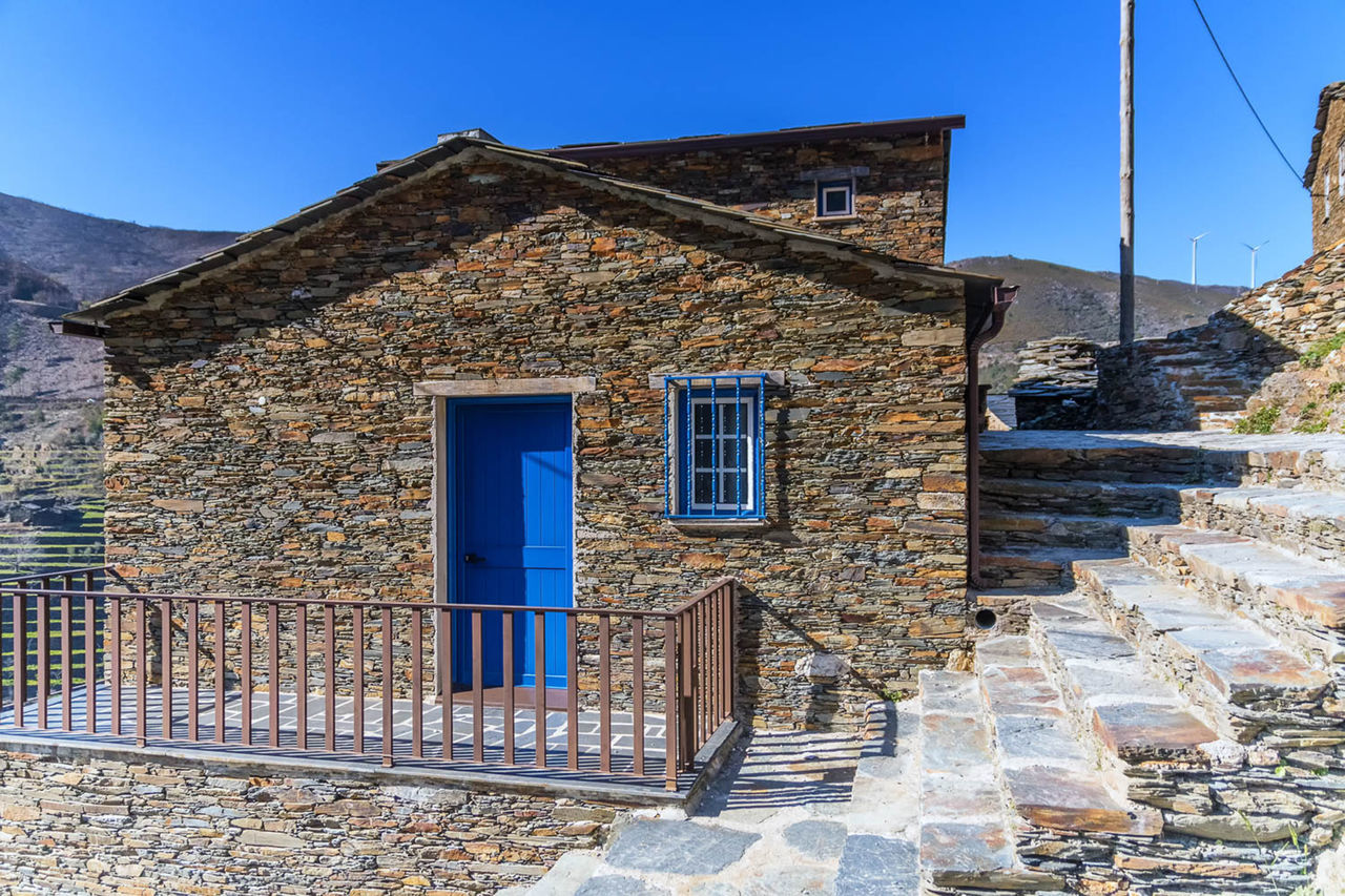 HOUSE AGAINST BLUE SKY