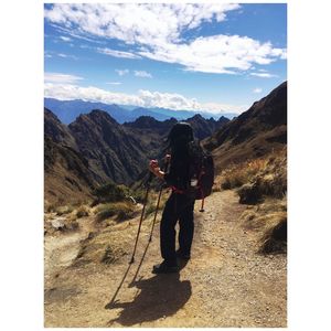 Man standing on mountain against sky