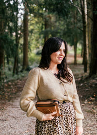 Young woman standing in a forest