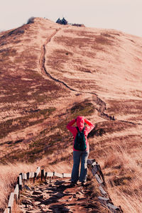 Rear view of woman standing on field