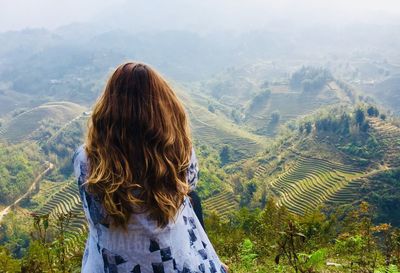 Rear view of woman looking at mountains