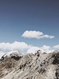 Low angle view of rocks on mountain against sky