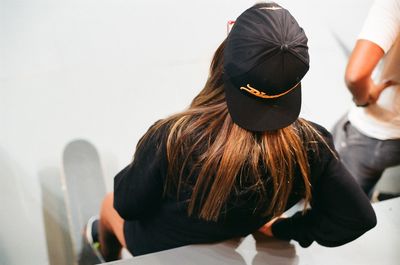 High angle view of female with skateboard standing by man