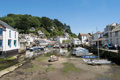 Boats moored on canal amidst buildings in town