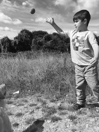 Full length of girl playing with arms raised