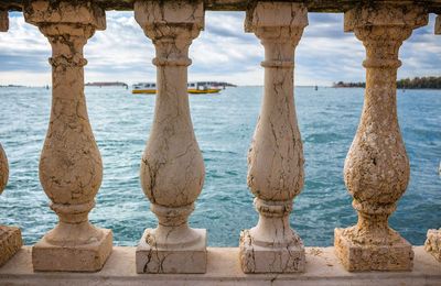 Scenic view of sea against sky seen through balustrades