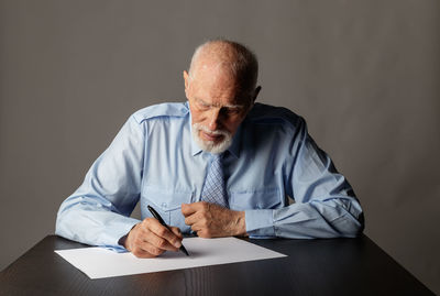 Midsection of a man sitting on table