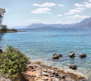 Scenic view of lake against cloudy sky