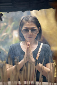 Asian woman praying at buddhist temple in thailand