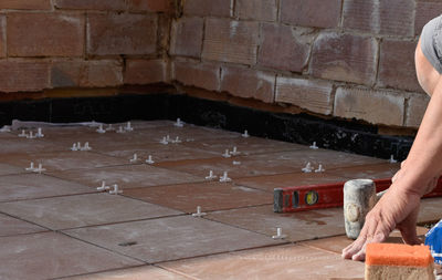 Hands of man working in masonry, unrecognisable