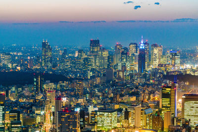 High angle view of city lit up at dusk