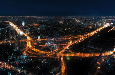 High angle view of illuminated buildings in city at night