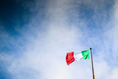 Low angle view of flag against blue sky