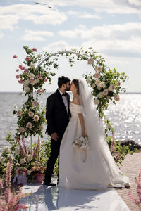 Midsection of bride holding bouquet