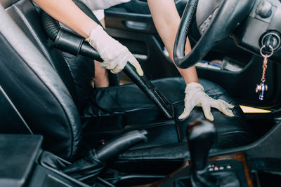 Midsection of man sitting in car