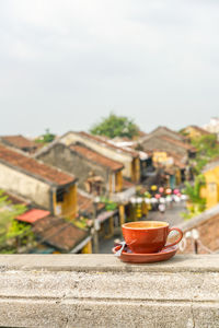 Close-up of tea against buildings