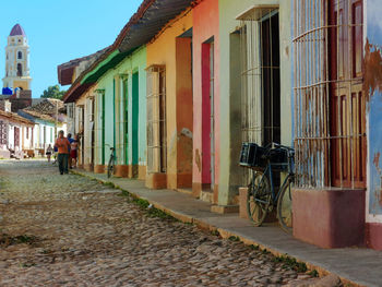 People walking on street amidst buildings