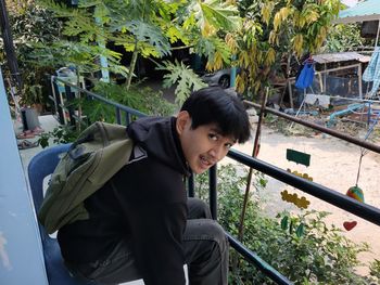 Portrait of young man against plants