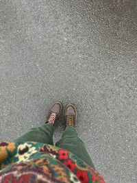 Low section of woman standing on road