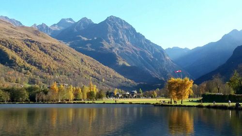 Scenic view of lake and mountains against sky 