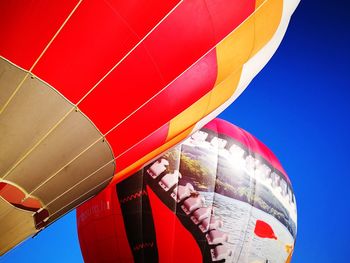 Low angle view of hot air balloon against blue sky