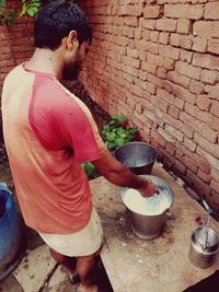 Side view of man preparing food