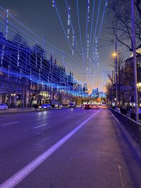 Illuminated bridge against sky at night