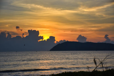 Scenic view of sea against orange sky