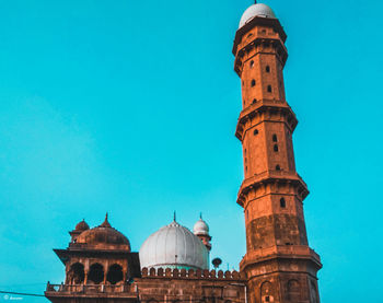 Low angle view of historic building against blue sky