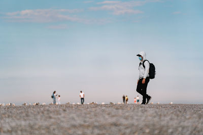 People on beach against sky