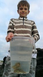 Portrait of boy holding bucket