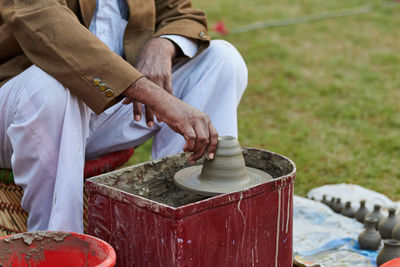 Midsection of man working in workshop