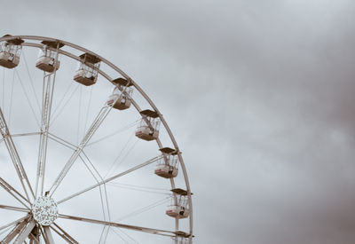 Low angle view of ferris wheel against sky