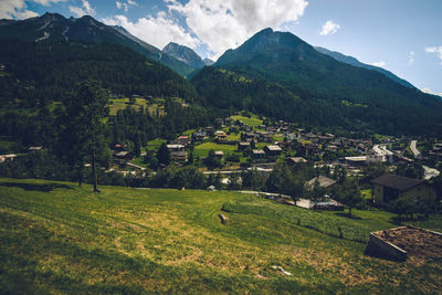 Scenic view of landscape and buildings against sky