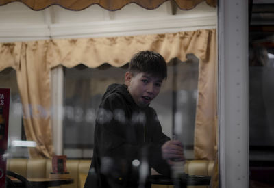 A beautiful boy child in a restaurant train car.