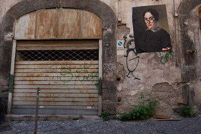 Portrait of man standing against building