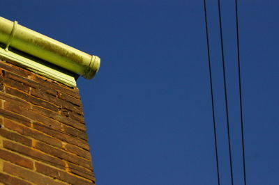 Low angle view of house against clear blue sky