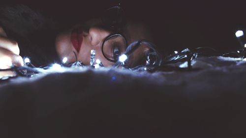 Close-up of woman with light candles