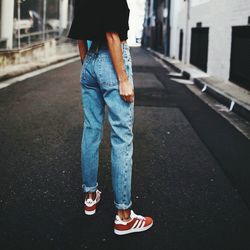 Low section of man standing on road