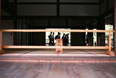 Woman standing by railing