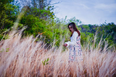 Full length of woman standing on field