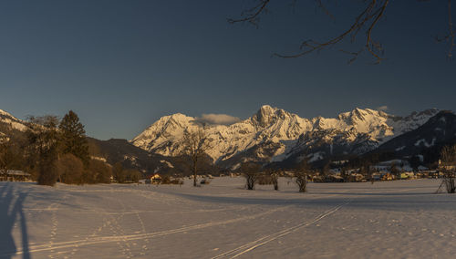 Scenic view of snowcapped mountains against clear sky