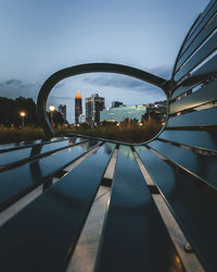 Part of atlanta skyline framed thru park bench.