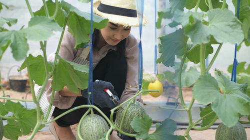 Midsection of woman holding plants